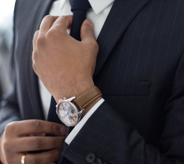 man wearing watch with black suit