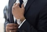 man wearing watch with black suit