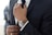 man wearing watch with black suit