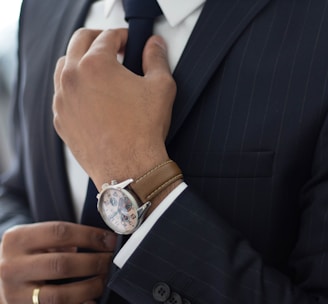 man wearing watch with black suit