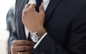 man wearing watch with black suit