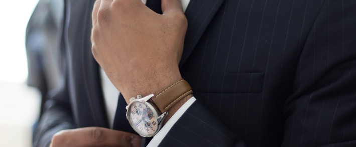 man wearing watch with black suit