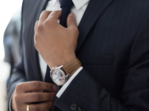 man wearing watch with black suit