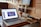 A cozy corner in a coworking space with a cup of coffee and a laptop.