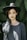 woman standing near trees wearing black hat