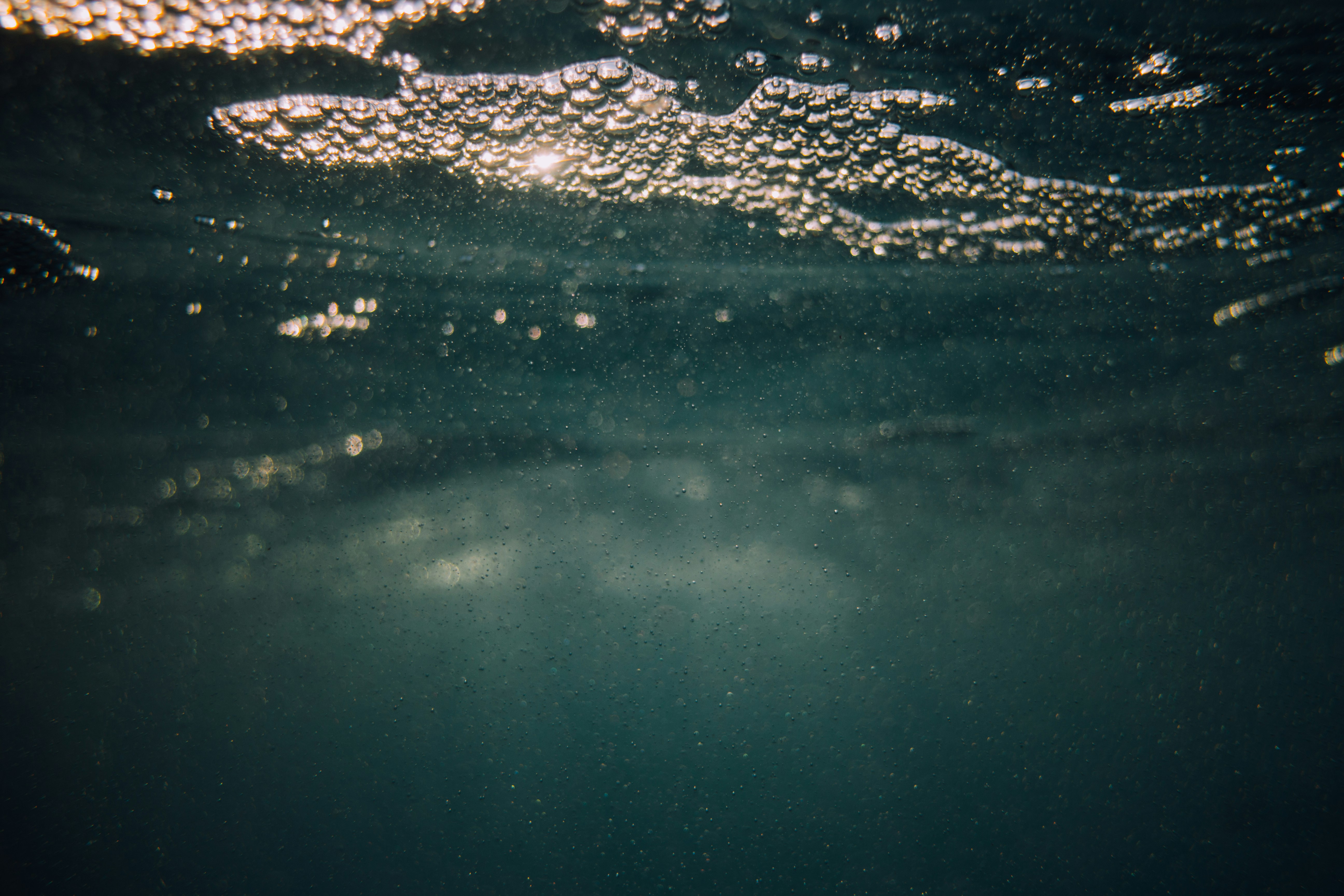 water with bubbles floating underwater photo
