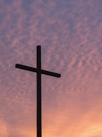silhouette of large cross during daytime