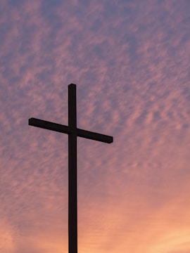 silhouette of large cross during daytime
