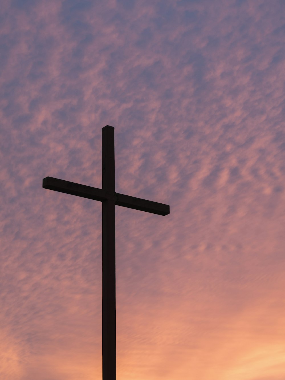 silhouette of large cross during daytime