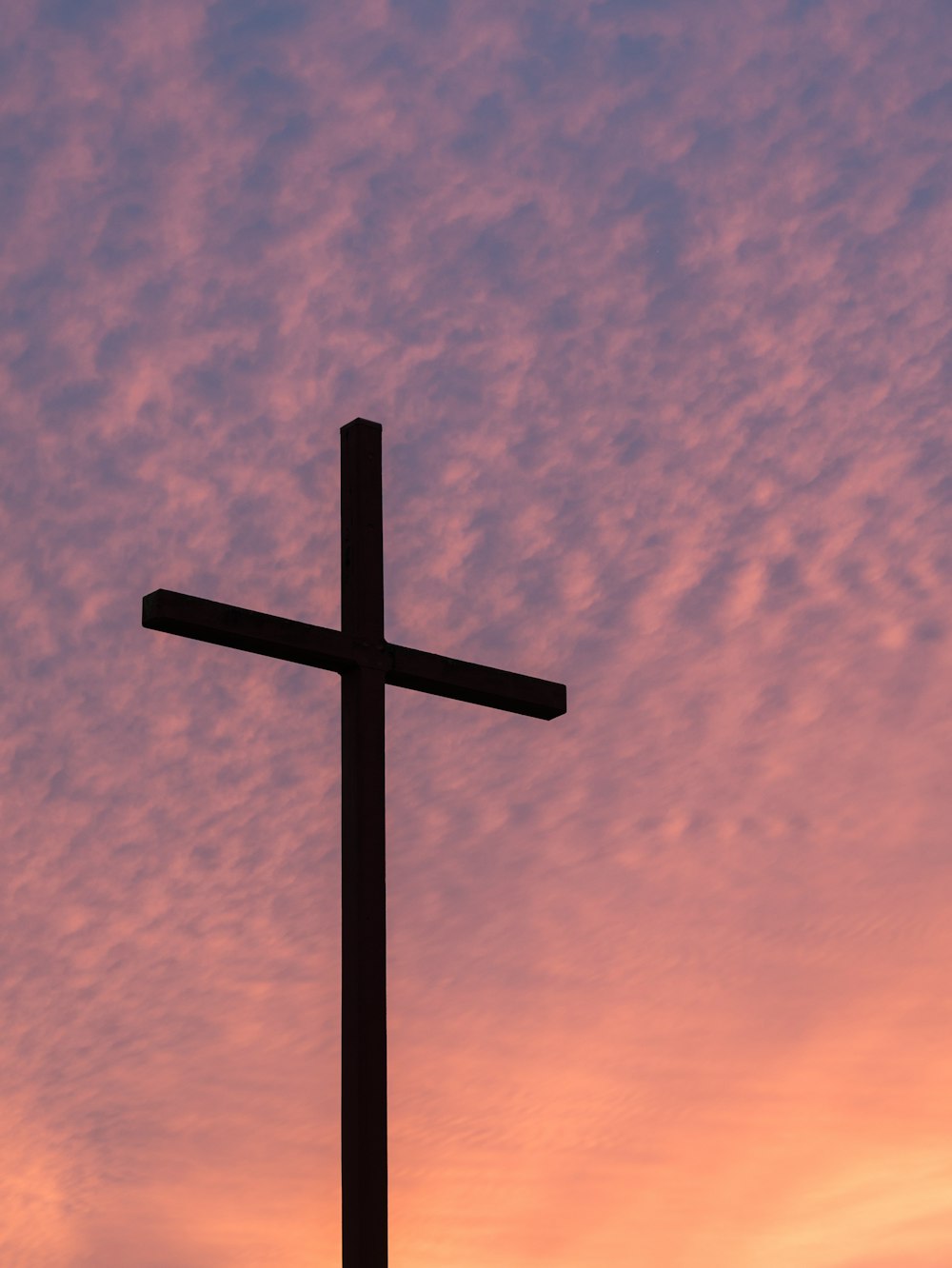 silhouette of large cross during daytime