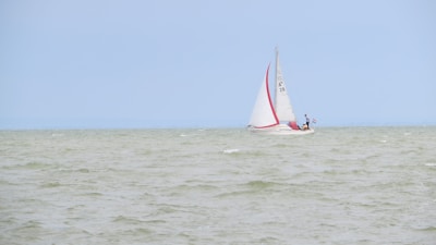 A professional instructor teaching sailing techniques on a sailboat.