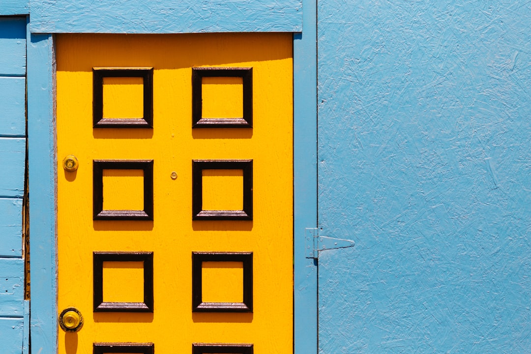blue and yellow wooden door