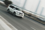 time lapse photography of white sport utility vehicle