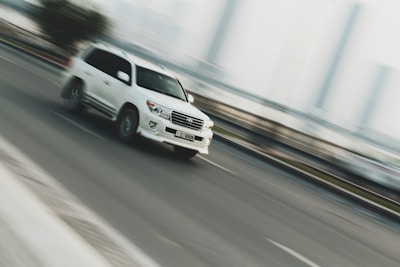 time lapse photography of white sport utility vehicle