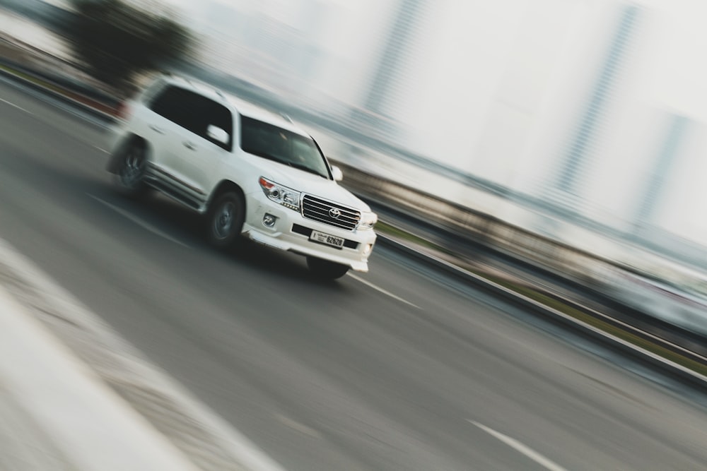 time lapse photography of white sport utility vehicle