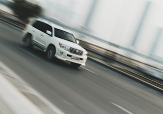 time lapse photography of white sport utility vehicle