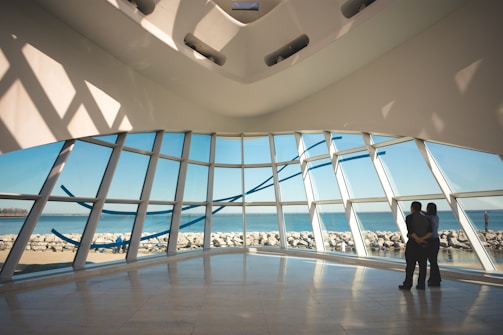 Open-plan living space with floor-to-ceiling windows capturing city and sea views.