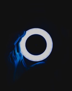 a person holding a glowing object in the dark