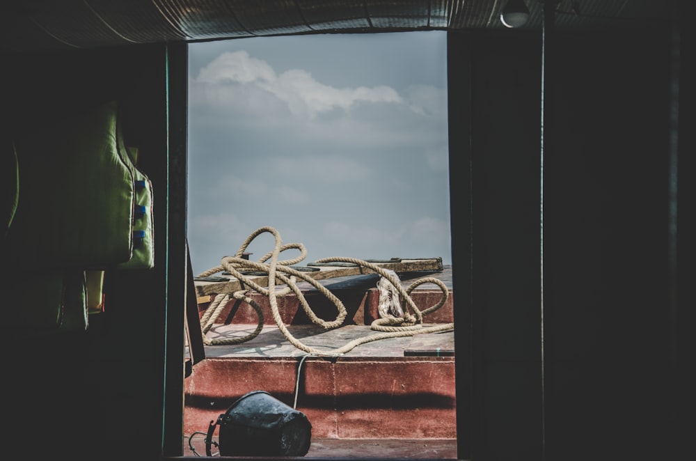 brown rope on brown wood slab outside building during daytime