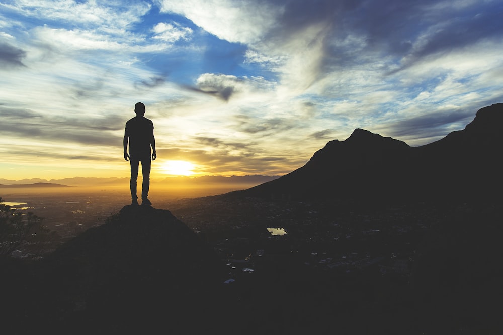 person standing at the top of mountain