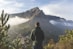 man standing in front of mountain