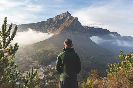 man standing in front of mountain in Table Mountain National Park South Africa