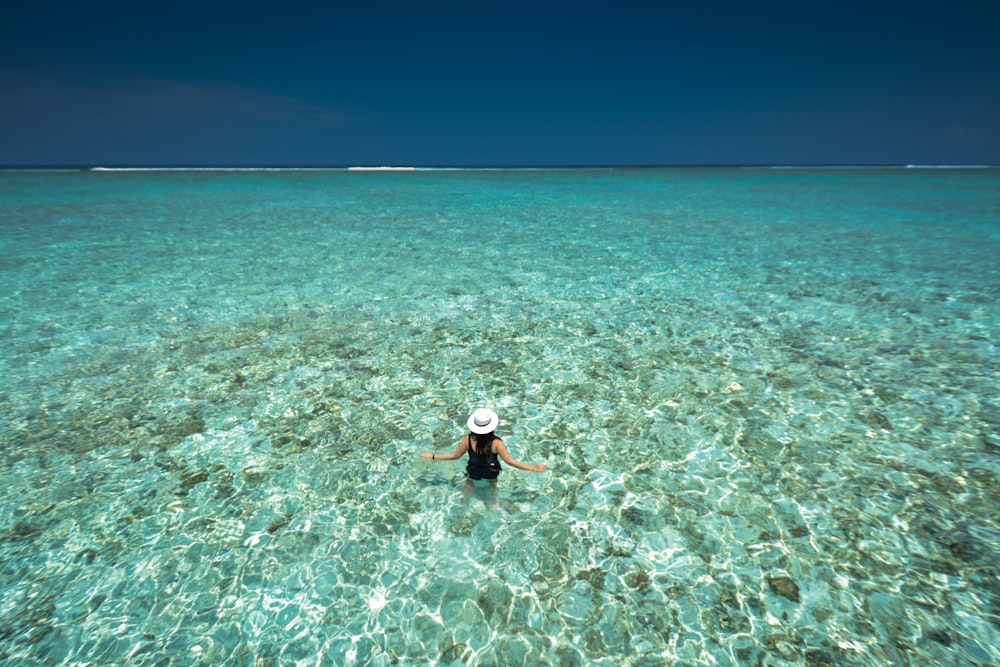 woman in body of water in birds eye photography