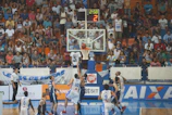 A lively basketball game in progress, players mid-action on the court.