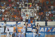 A panoramic view of a basketball game with players in mid-action.