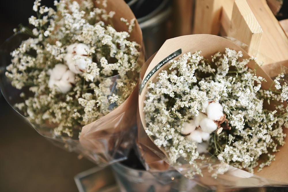 two baby's breath flowers and cotton bolls bouquets