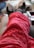 A person is lying down with their feet up, wearing fuzzy red patterned pants and thick socks. The focus is on the legs and feet, giving a cozy and relaxed atmosphere.