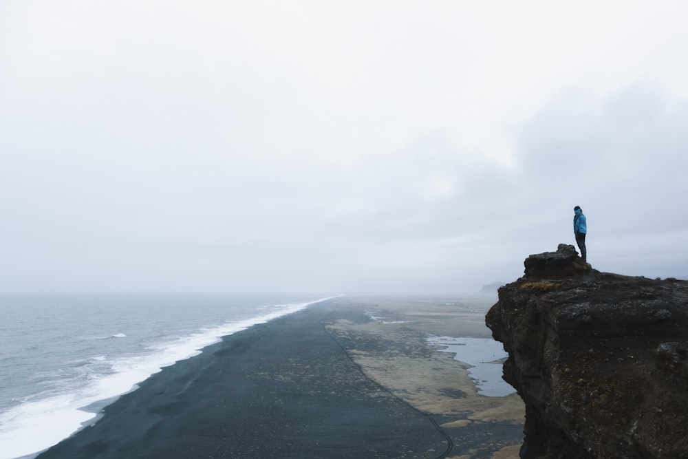 person on hilltop during daytime