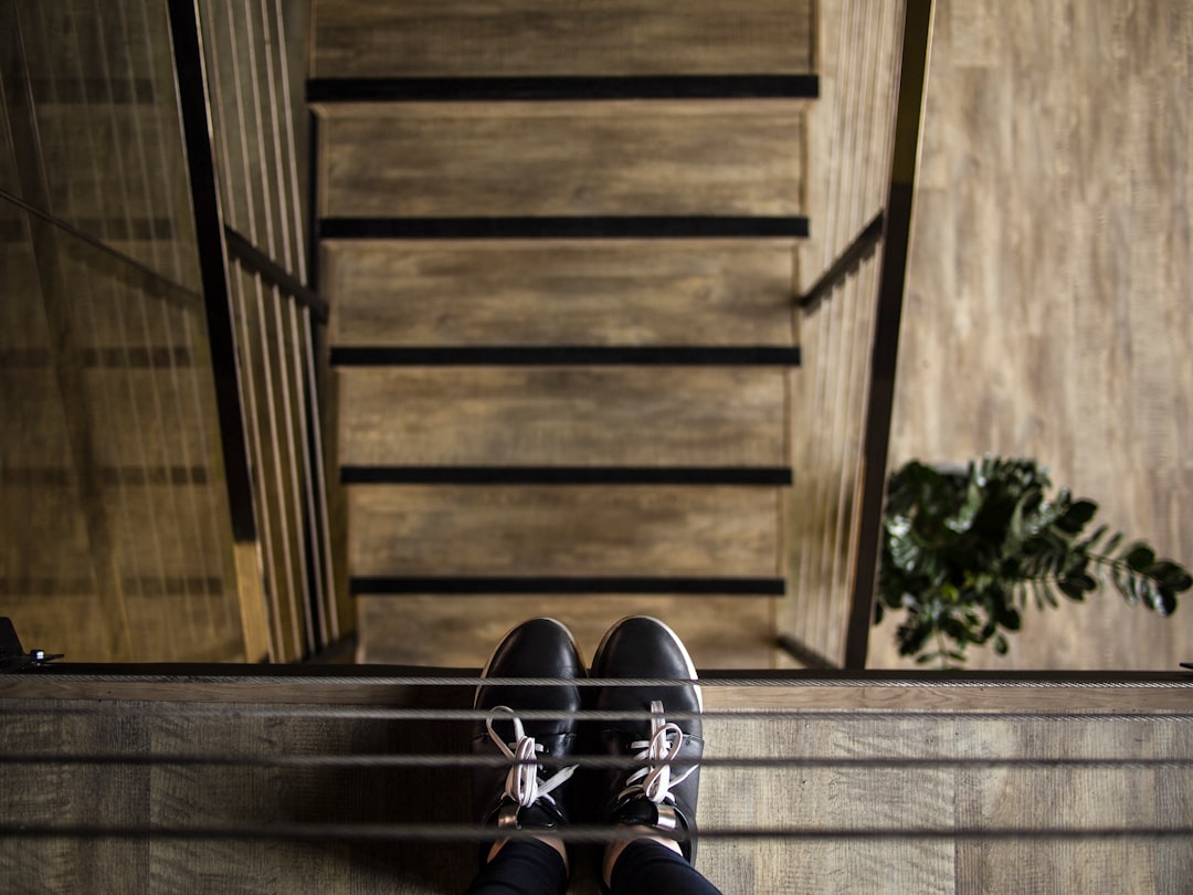 person standing near railing looking down