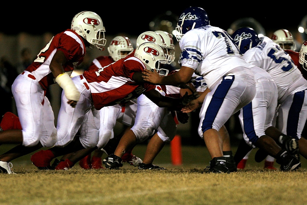 High school offensive and defensive linemen clash in a game in Texas.