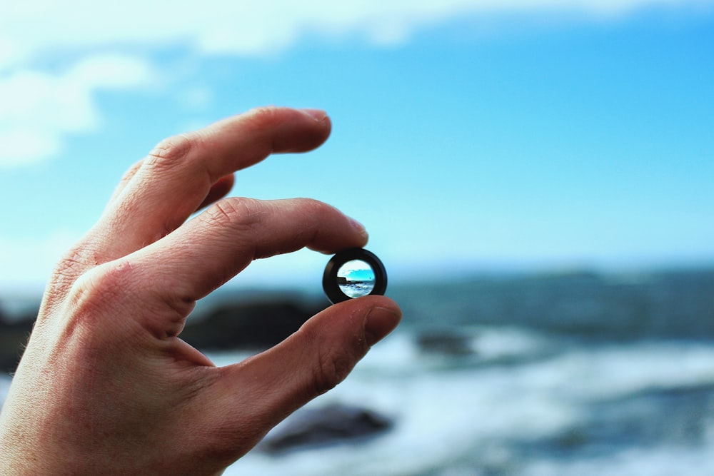 person holding black ring