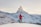 person in red hoodie standing on snowy mountain during daytime