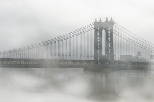 fog over Brooklyn Bridge during daytime in Manhattan Bridge United States