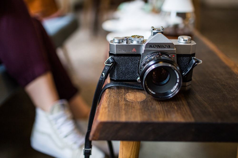 selective focus photography of Konica DSLR camera on table