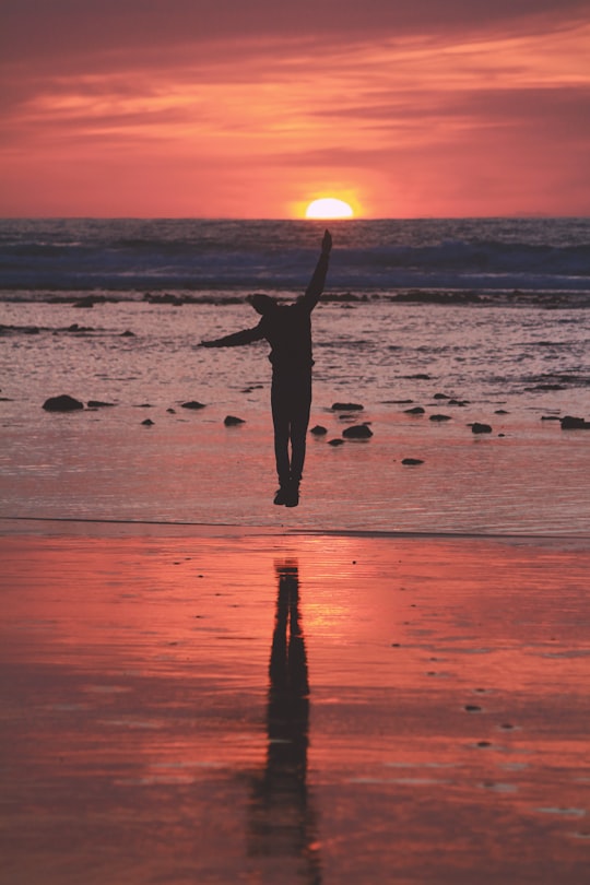 woman in black dress standing on beach during sunset in Aït Benhaddou Morocco