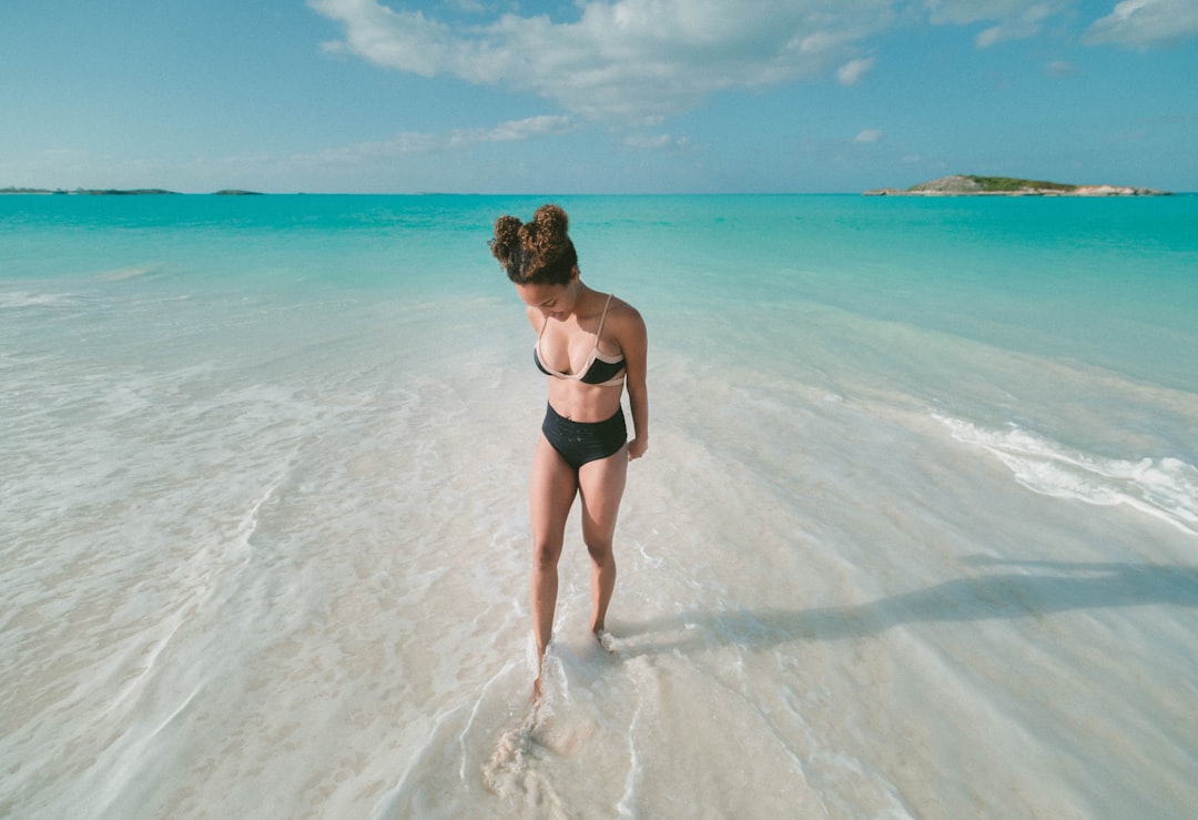 woman wearing bikini swimsuit while standing on beach seashore at daytime, Toes In The Sand