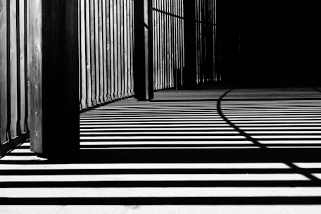 pillar of building shadows grayscale photography