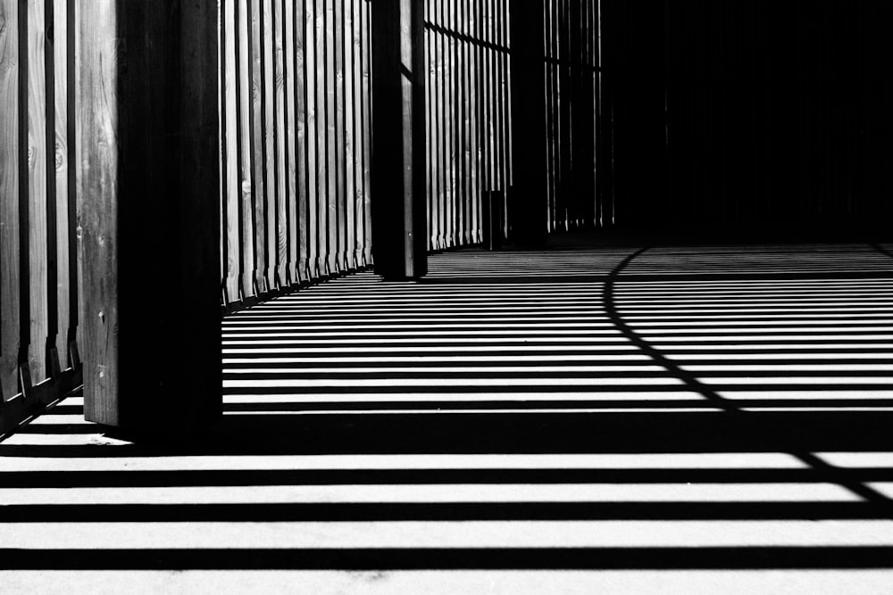 pillar of building shadows grayscale photography