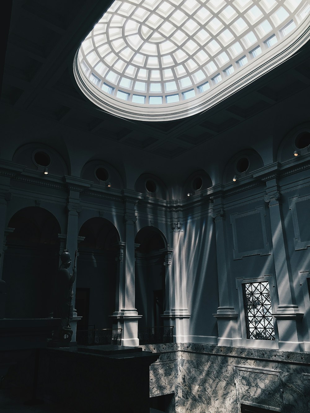 glass panel roof near arch-shaped doorways