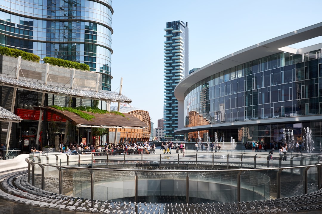 people gathering near building and round railings at daytime,