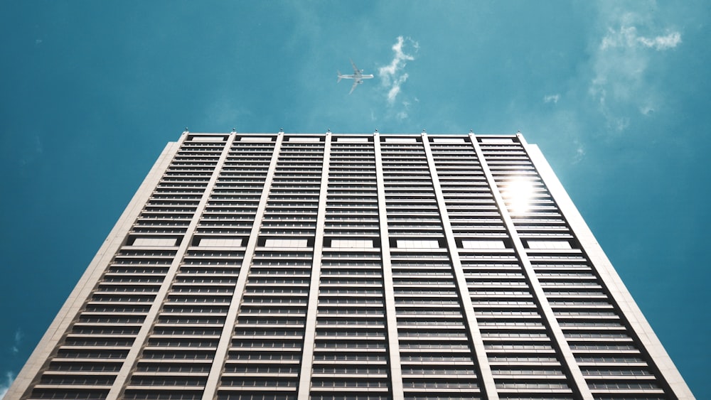 white high-rise building under blue and white skies