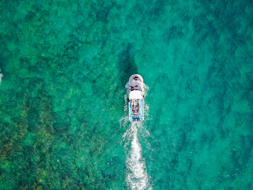 aerial photo of white boat sailing on body of water at daytime, With 72% of our earth covered by water it’s still unknow