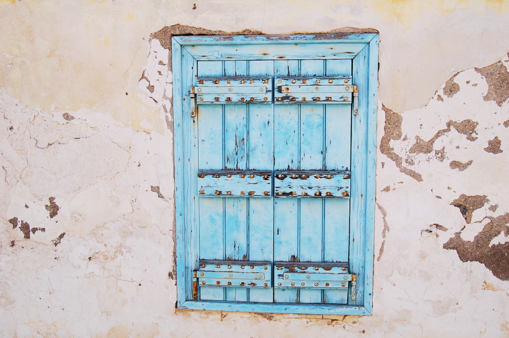 closed blue wooden window