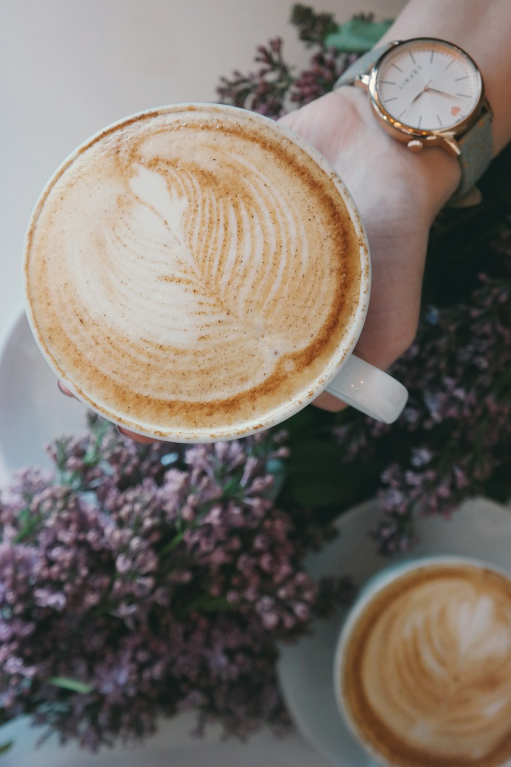 person holding white ceramic espresso cup