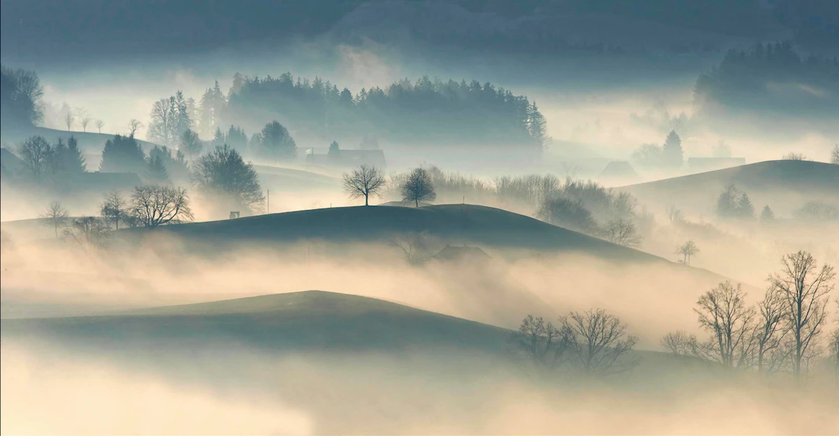 Silhouette of layered mountain ranges at dusk