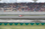 A dynamic shot of a red Ferrari on a racetrack.